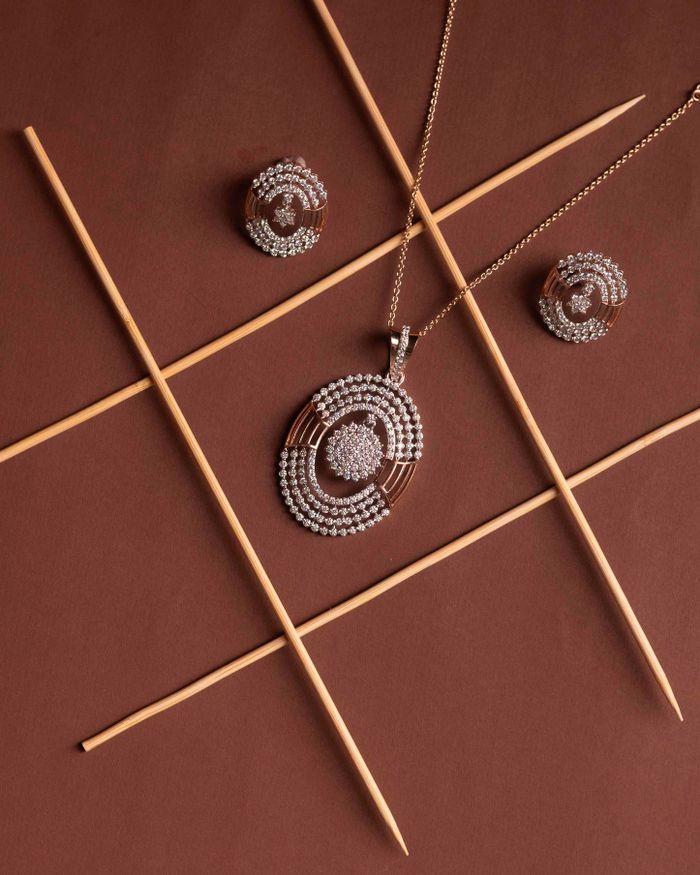 Diamond necklace and earring set displayed against a warm brown background
